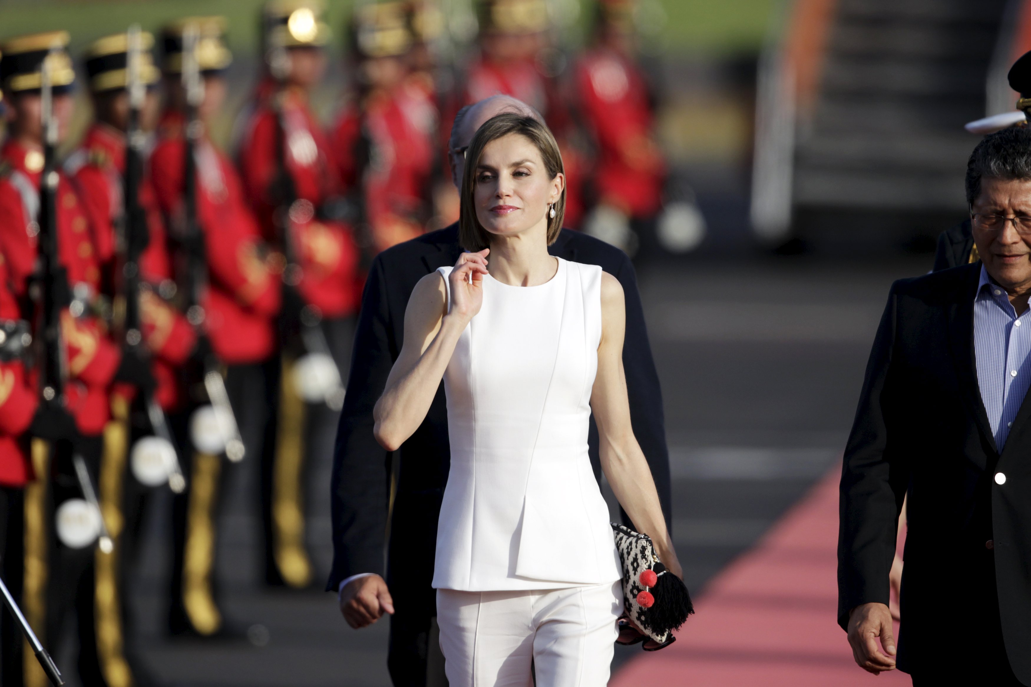 Spain's Queen Letizia walks with El Salvador's Vice-Minister of Foreign Affairs Jaime Miranda after her arrival for an official visit, at the Oscar Arnulfo Romero International Airport in Comalapa
