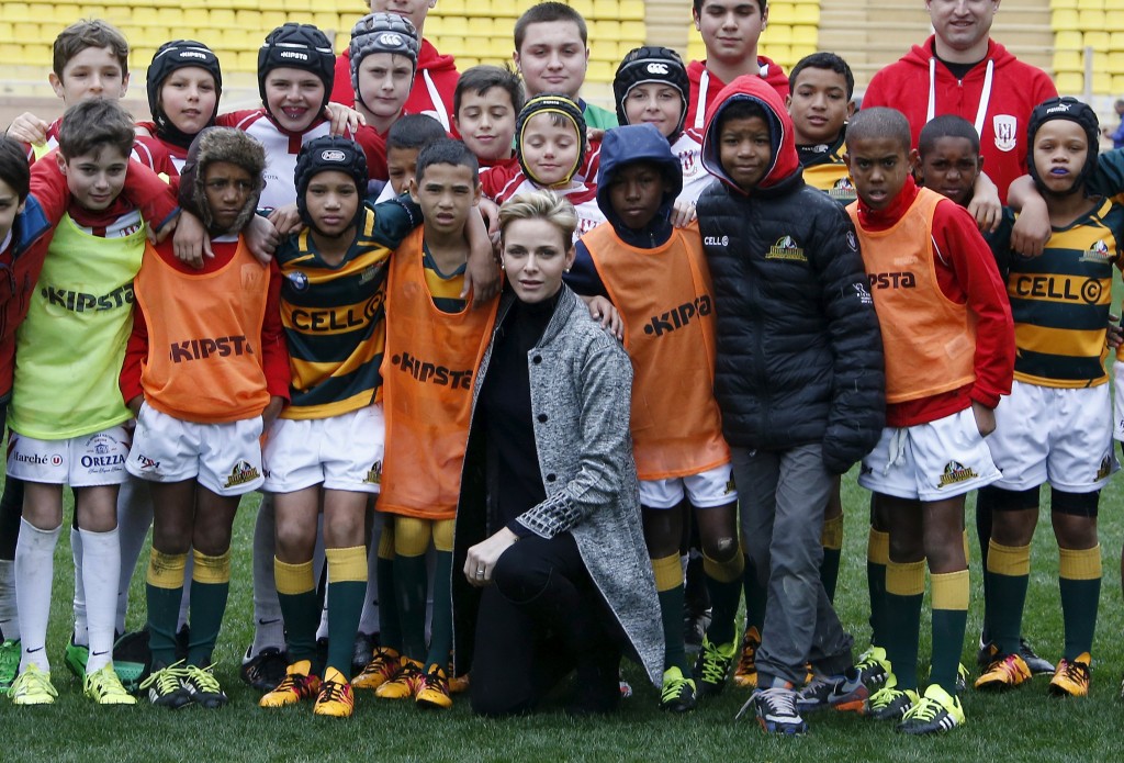 Princess Charlene of Monaco poses with rugby players during Sainte Devote rugby tournament at Louis II Stadium in Monaco