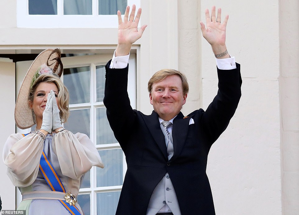 Dutch King Willem-Alexander and Queen Maxima wave to well wishers from the balcony of Noordeinde Royal Palace